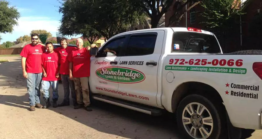 Stonebridge Lawn & Garden Team members with a car