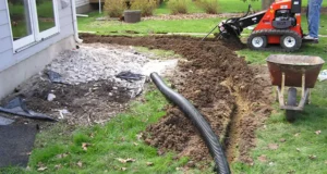 French drain installation in McKinney, TX showing trenching and pipe placement near home foundation