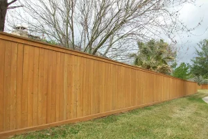 Tall wooden privacy fence installation providing durability and curb appeal for residential backyard in Prosper, Texas
