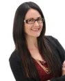 a beautiful woman smiling and wearing an eyeglass