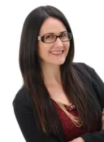 a beautiful woman smiling and wearing an eyeglass
