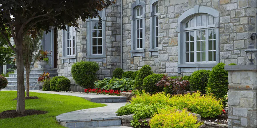 A house with a beautiful garden and walkways in Frisco